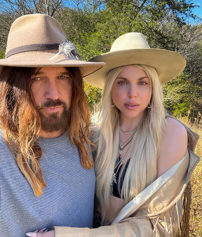 A couple wearing hats poses outdoors, stirring reactions with debut romance. A couple wearing hats poses outdoors, stirring reactions with debut romance.