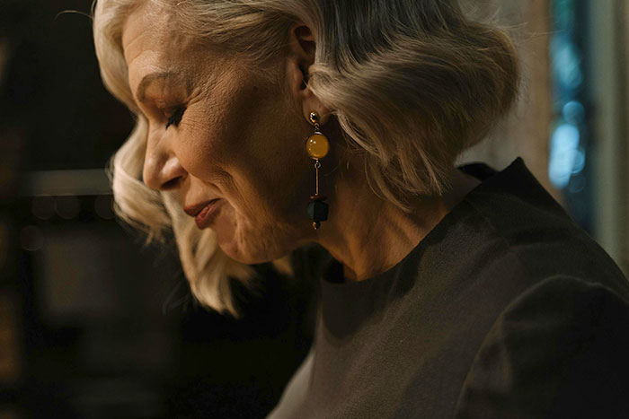 Elderly woman with stylish earrings, side profile. Elderly woman with stylish earrings, side profile.
