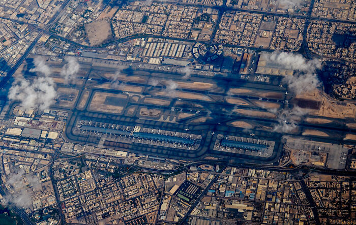 Aerial view of a busy airport, highlighting runways and terminals, representing one of 2024's top 10 busiest airports. Aerial view of a busy airport, highlighting runways and terminals, representing one of 2024's top 10 busiest airports.