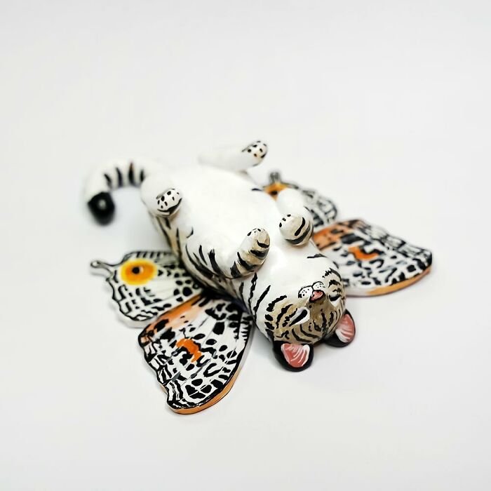 Adorable pocket-sized animal figurine with detailed wing patterns by Vallavica.