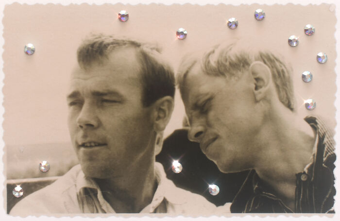 Two men share a moment of closeness, symbolizing love without boundaries, with decorative rhinestones around the photo.