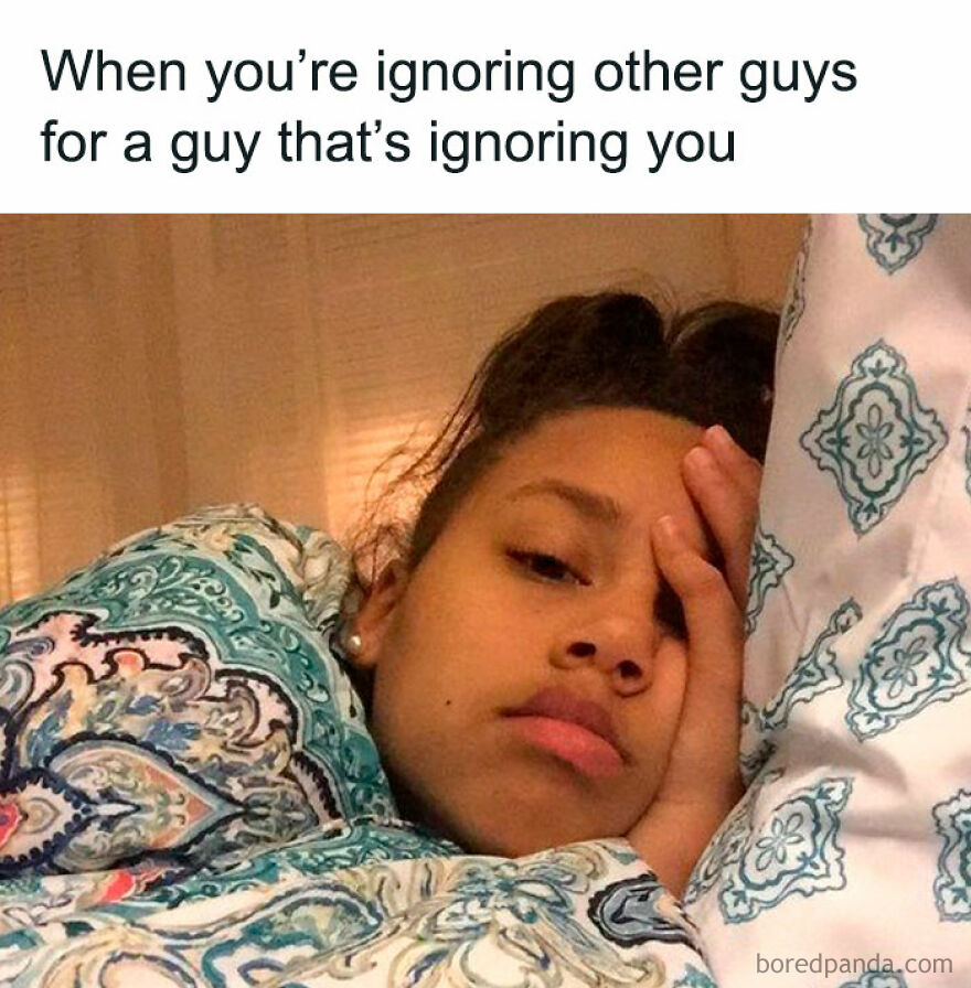A girl lying in bed, looking frustrated, with text about ignoring guys. Hilarious meme related to dating experiences.