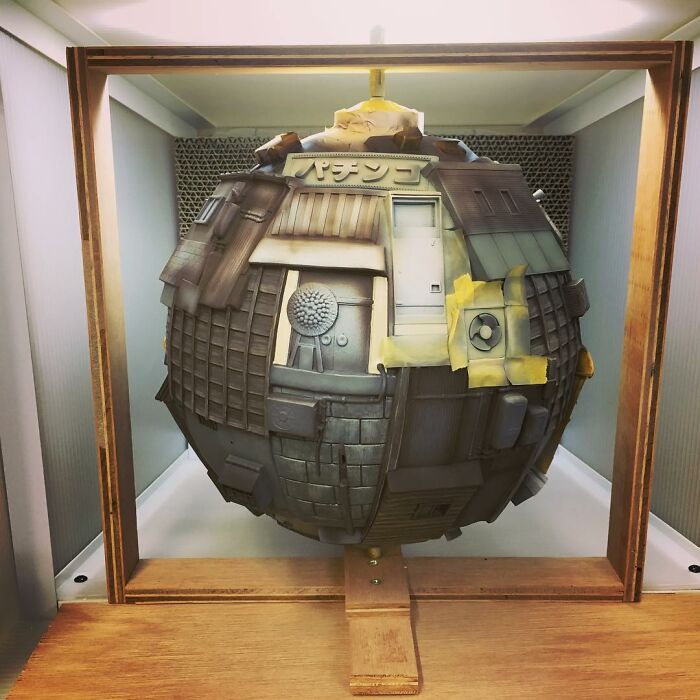 Surreal floating sphere artwork representing post-apocalyptic urban cities with detailed textures and architectural elements.