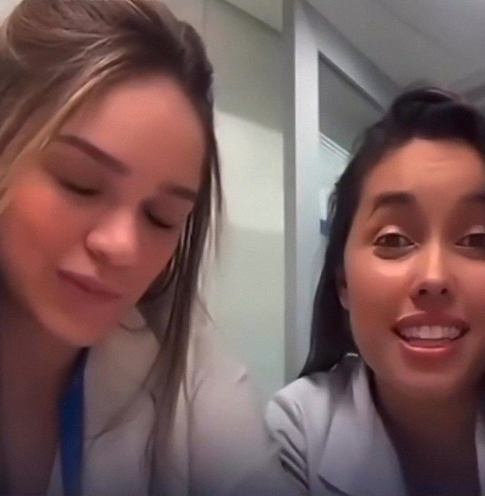 Medical students in a bright room, one smiling, related to transplant controversy. Medical students in a bright room, one smiling, related to transplant controversy.