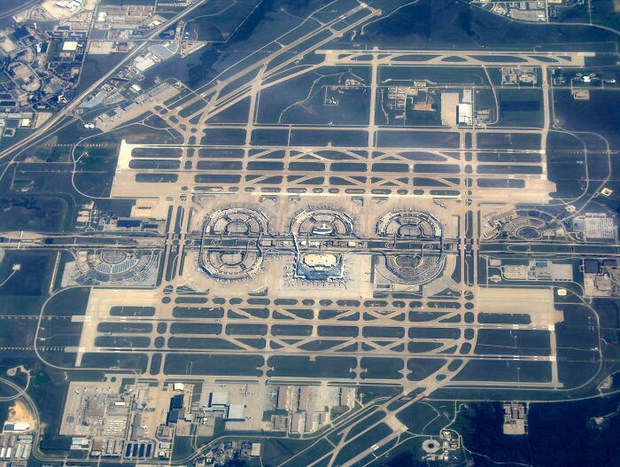 Aerial view of one of the busiest airports in 2024, showcasing extensive runways and terminals. Aerial view of one of the busiest airports in 2024, showcasing extensive runways and terminals.