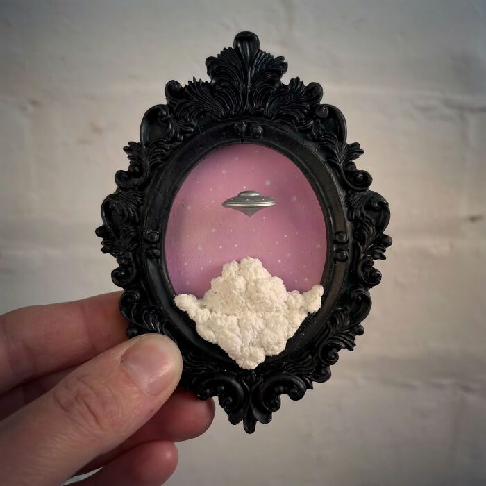 Intricate diorama featuring a UFO, set against a pink sky, designed for alien and mystery enthusiasts.