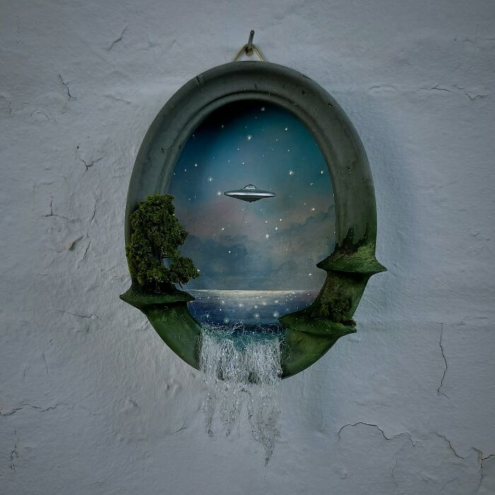Alien-themed diorama by Caroline Dewison, featuring a UFO over a starry landscape with trees and a waterfall.