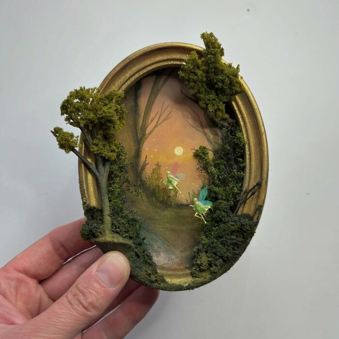 Miniature forest diorama with glowing fairies and a sunset, perfect for alien and mystery aficionados.