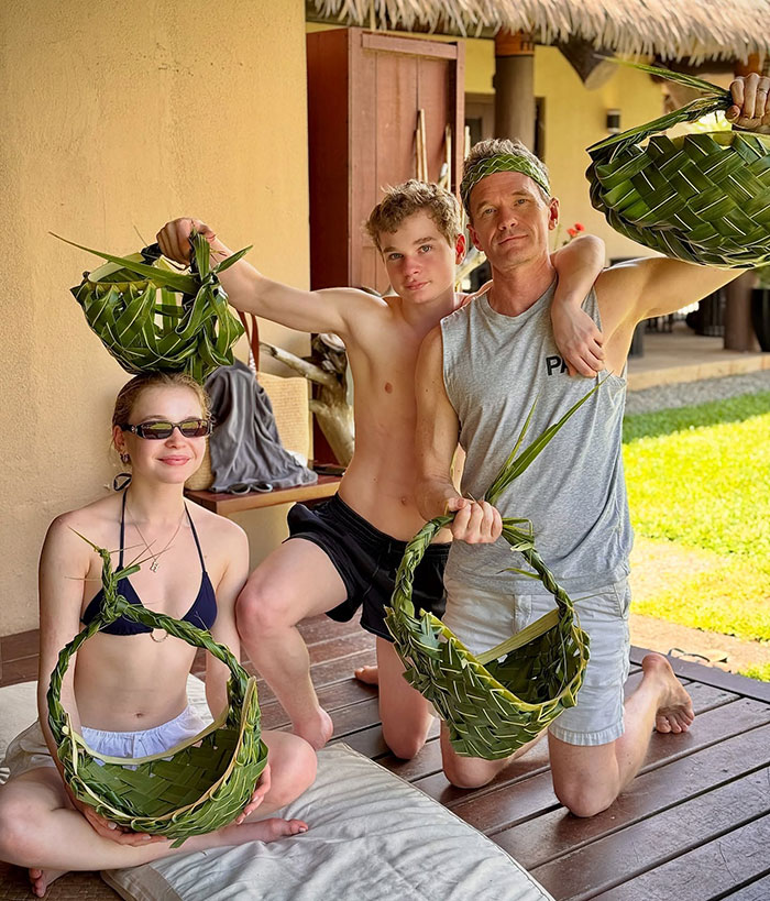 Group posing with woven baskets on a Fiji trip, enjoying a sunny day outdoors. Group posing with woven baskets on a Fiji trip, enjoying a sunny day outdoors.
