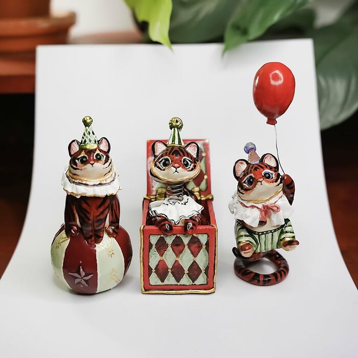Adorable pocket-sized animal figurines by Vallavica, featuring three whimsical cat designs with circus attire.