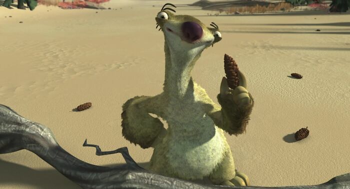 Animated character in a desert scene holding a pine cone, illustrating a moment from a humorous adventure.