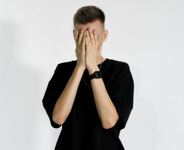 Man with hands on face, stressed over family wanting breakup after girlfriend fights prank. Man with hands on face, stressed over family wanting breakup after girlfriend fights prank.