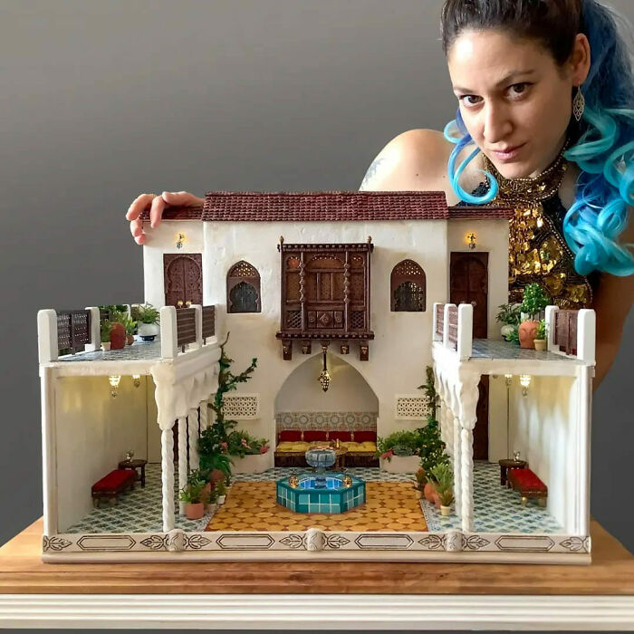 Tamar Cohen showcasing mesmerizing miniatures, featuring a detailed tiny world with intricate architecture and vibrant decor.