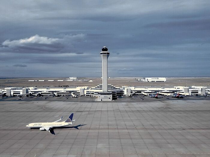 Busiest airport in 2024 with a control tower and a plane on the tarmac under cloudy skies. Busiest airport in 2024 with a control tower and a plane on the tarmac under cloudy skies.