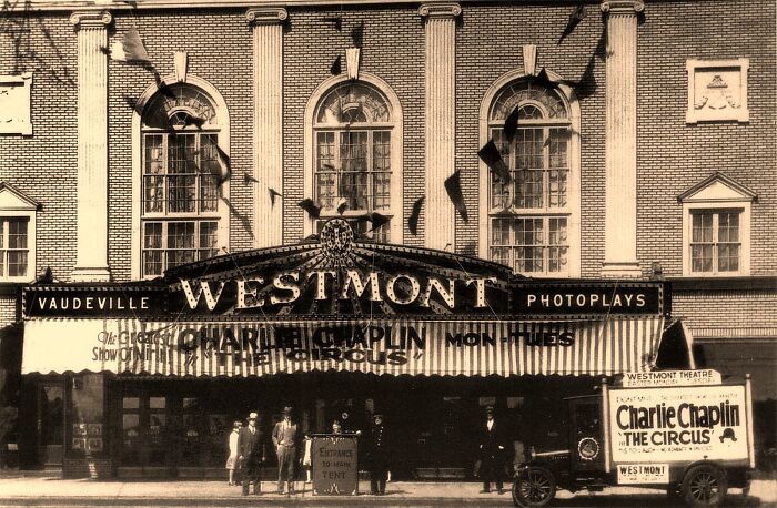 Historic photo of Westmont Theatre marquee showing Charlie Chaplin The Circus, illustrating life in America from 100 years ago.