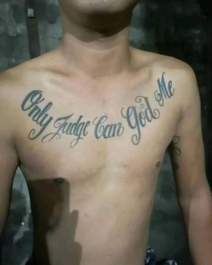 Man with a hilariously bad tattoo on his chest, showcasing a typo in bold script.