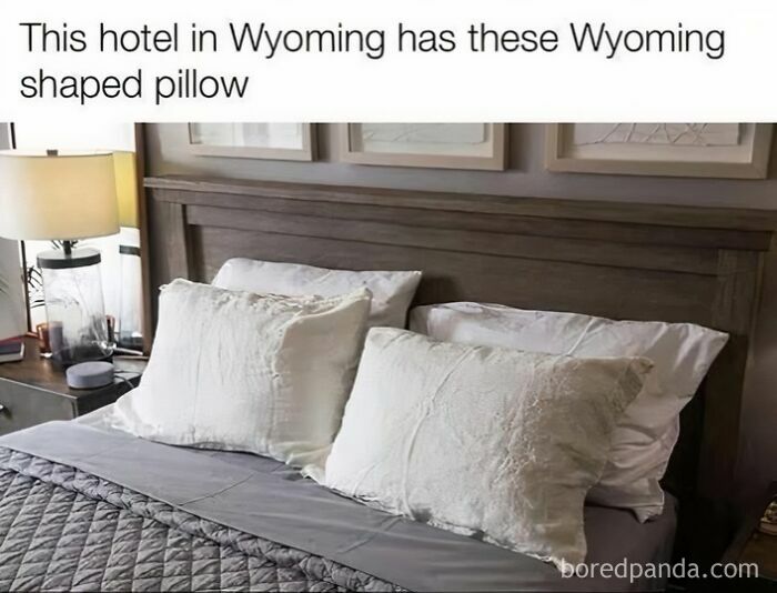 Wyoming-shaped pillows on a hotel bed, embodying a literal meme with a humorous twist.
