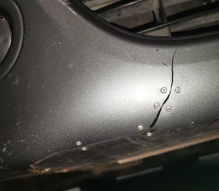 Failed repair attempt on c*****d car bumper held with screws.