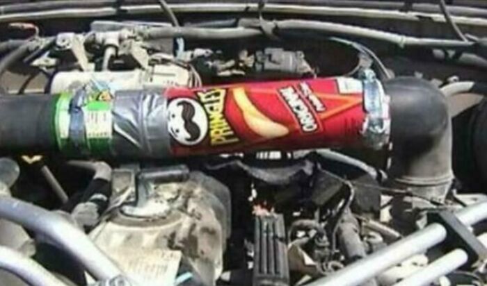 Engine repair using a Pringles can and duct tape, highlighting a failed repair attempt.