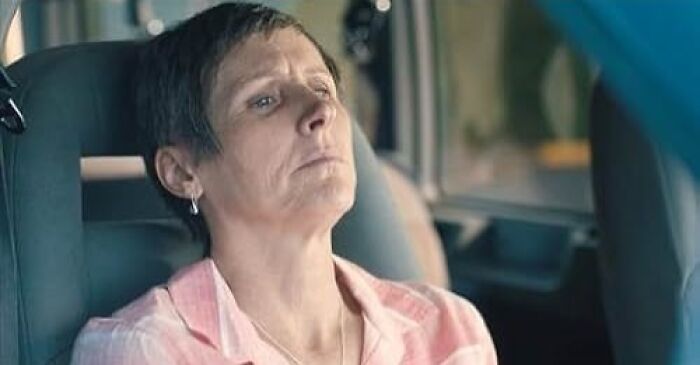 A woman in a car looking emotional, highlighted in a list of movies proven to cause tears.
