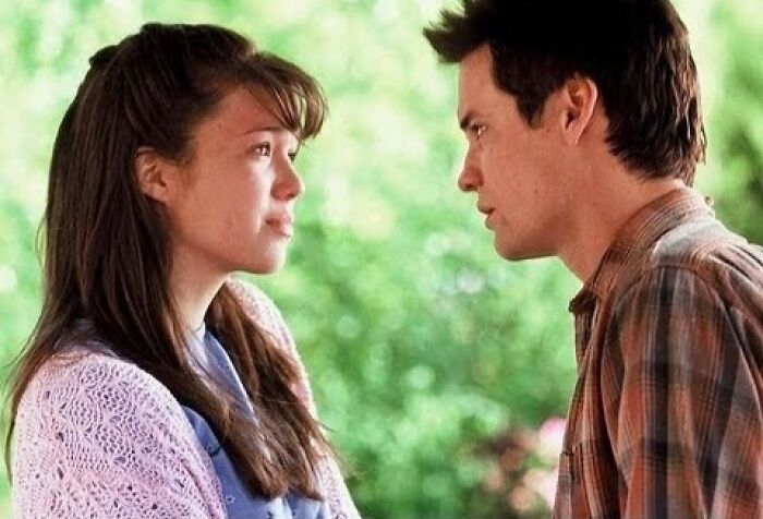 A couple shares an emotional moment outdoors, reflecting a tearful movie scene.