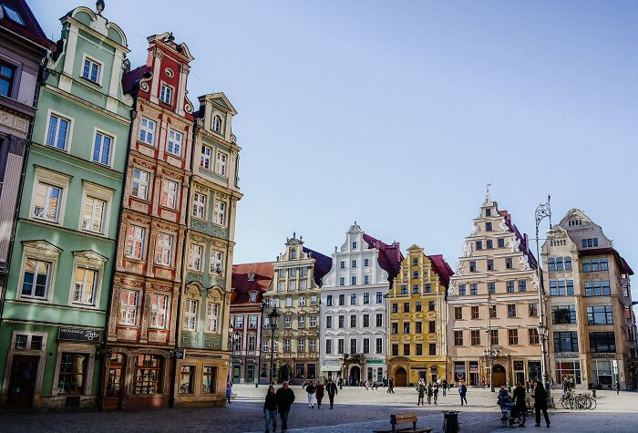 Colorful city buildings under clear sky, resembling a real life painting.