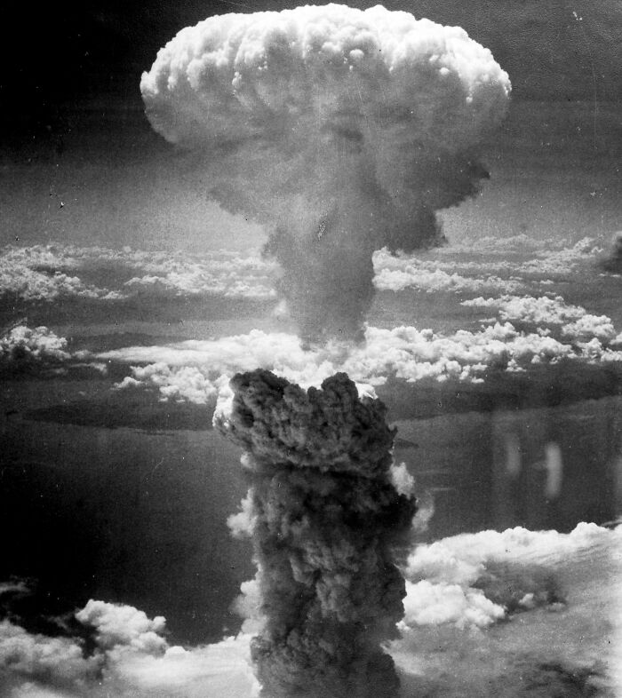 Mushroom cloud from an atomic explosion, illustrating historical coincidences and their impact.