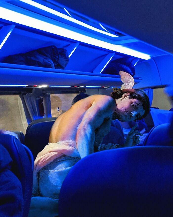 Classical figure in a modern bus setting, under blue lighting, illustrating Alexey Kondakov's artistic blend.