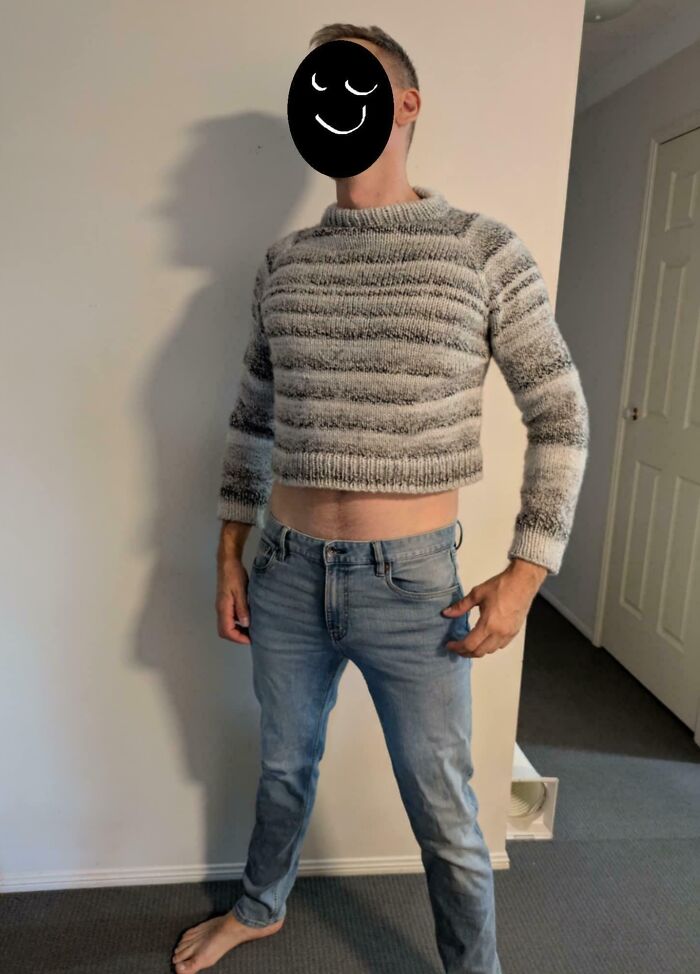 Man in a too-small sweater and jeans, showcasing a fashion mishap for a humorous take on having a worse day.