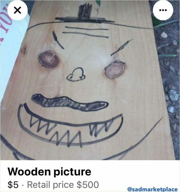Wooden board with a cartoon face drawing, listed on Facebook Marketplace for $5.