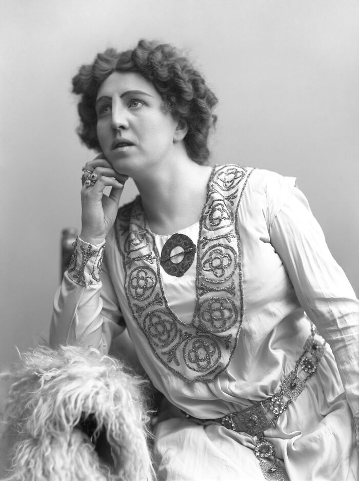 Black and white rare photograph of a woman in ornate dress rescued from glass negatives in history restoration.