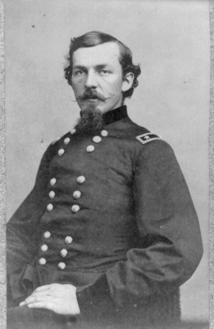 Portrait of a 19th-century military officer in uniform, featured in rare photographs restored from glass negatives.