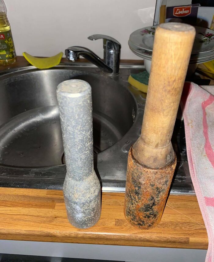 Two rolling pins placed by a sink, with one looking worn and rusty, suggesting a bad day in the kitchen.