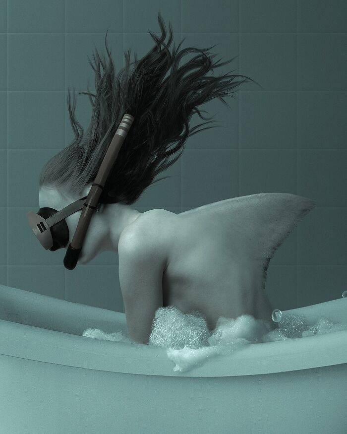A surreal Photoshop self-portrait of an artist in a bathtub with a shark fin and snorkel, blending reality and dreams.