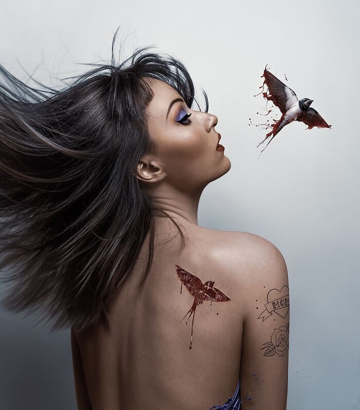 Artist uses Photoshop for surreal self-portrait with bird motif and tattoos.