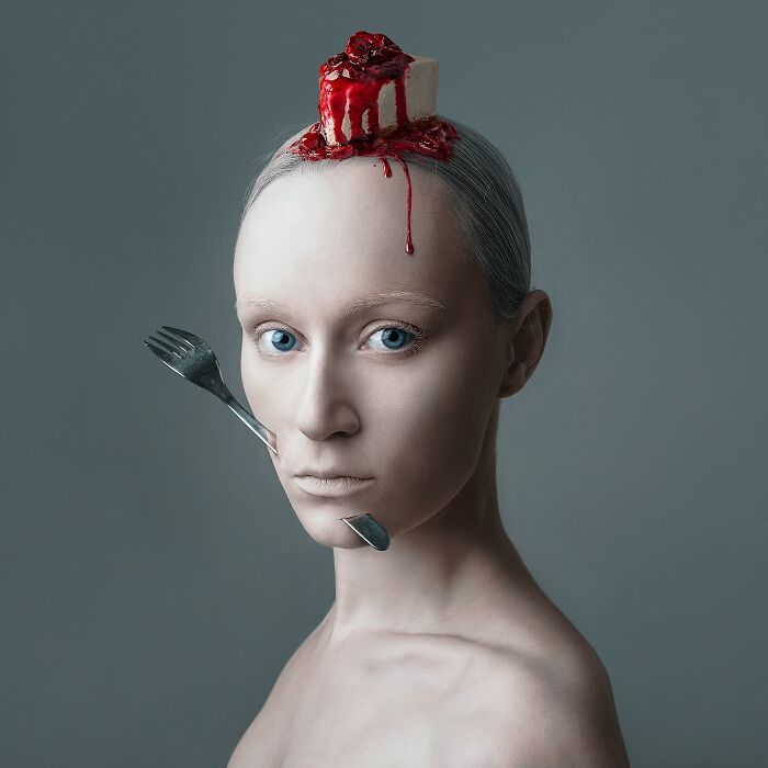 Surreal self-portrait with cake on head and fork on cheek, using Photoshop to create dreamlike imagery.