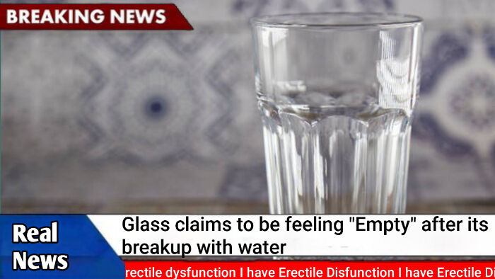 Glass humorously described as feeling empty after breakup with water in a completely unremarkable photo.