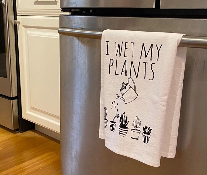 Kitchen towel with a funny plant watering joke, a humorous Mother's Day gift idea for moms who love gardening and humor.