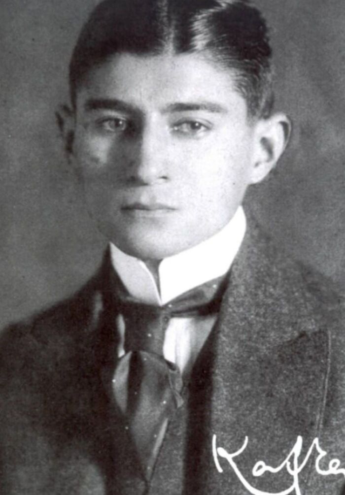 Young man in formal attire, with slicked hair, representing historical figure, connected to interesting stories globally.