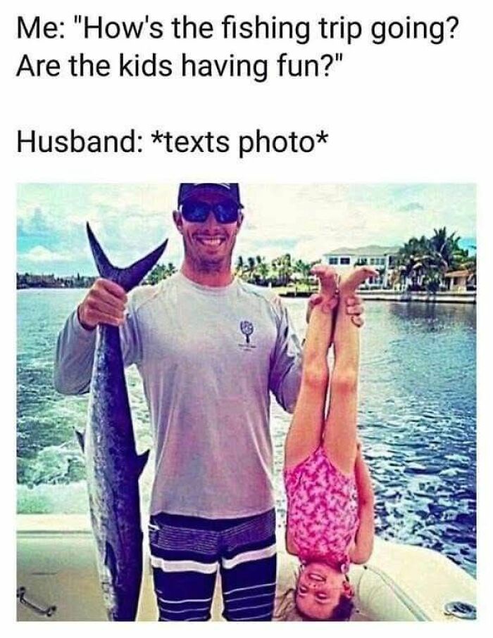 Man holding large fish and daughter upside down on boat, showcasing funny dad joke humor from fishing trip photos.