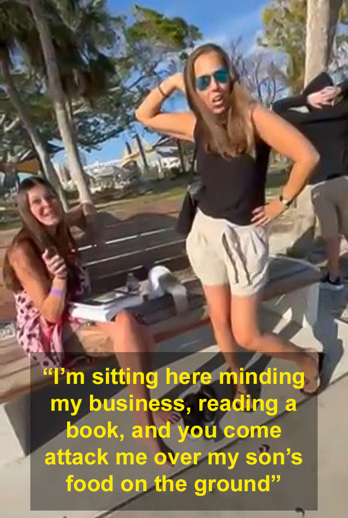 Women arguing at a park bench; one stands with hands on hips, the other sits, laughing. Women arguing at a park bench; one stands with hands on hips, the other sits, laughing.