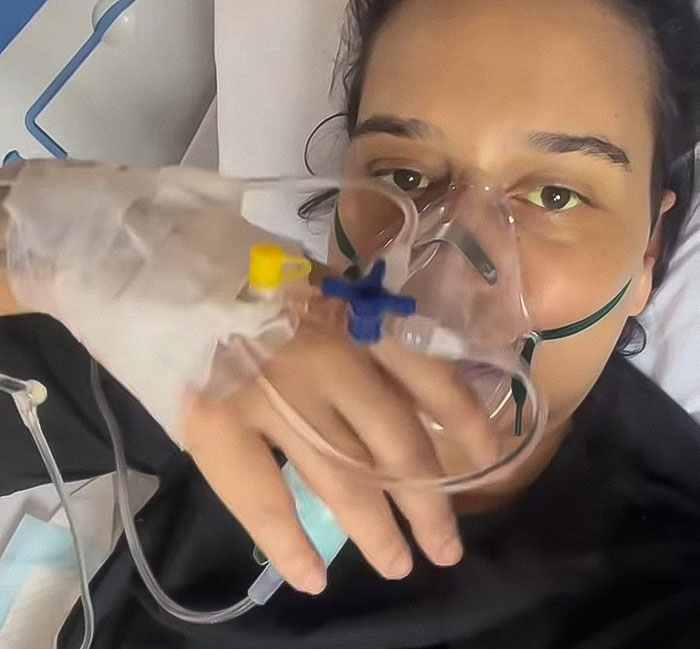 Young woman, 28, with IV and oxygen mask hospitalized due to mysterious illness while traveling. Young woman, 28, with IV and oxygen mask hospitalized due to mysterious illness while traveling.