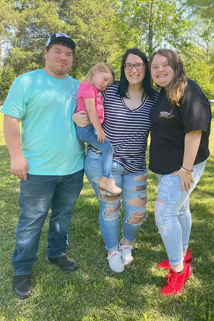 Family posing outdoors in casual attire on a sunny day, related to Honey Boo Boo's turbulent life. Family posing outdoors in casual attire on a sunny day, related to Honey Boo Boo's turbulent life.