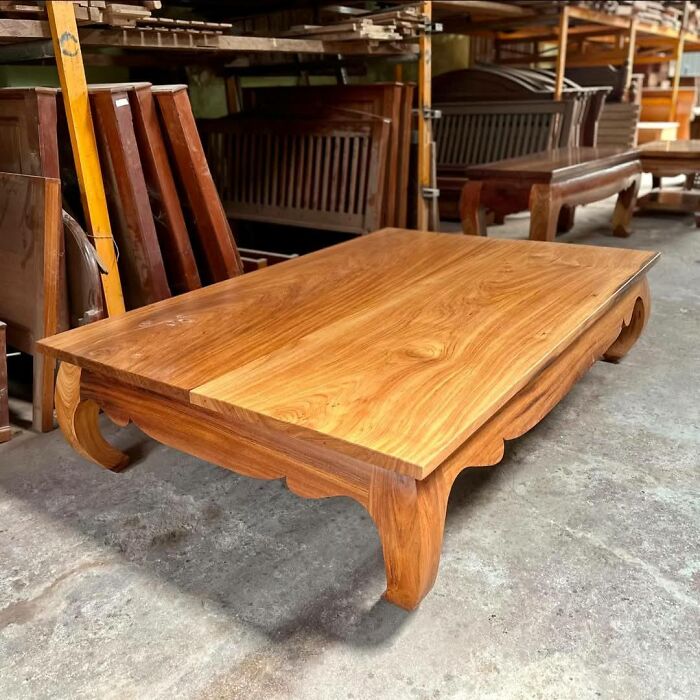 Beautifully crafted woodworking project showcasing a solid wood table with intricate legs in a workshop.