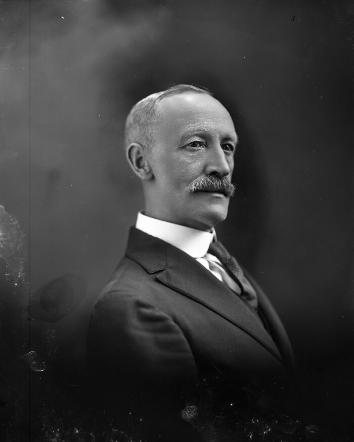 Black and white portrait of an elderly man with a mustache, showcasing rare photographs rescued from glass negatives.