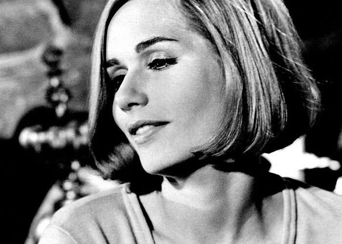 A celebrity smiling gently, showcasing kindness and elegance in a candid black and white portrait.