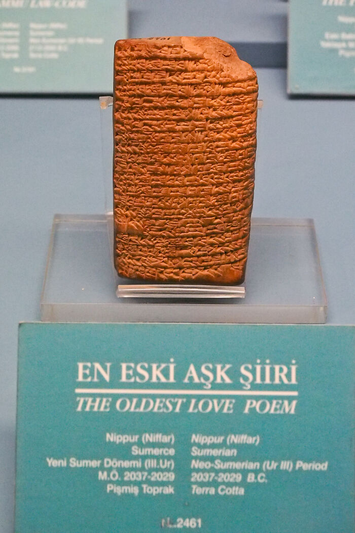 Ancient written text, the oldest love poem, on display in a museum exhibit.