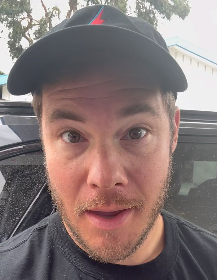 Actor involved in cement truck crash, wearing a black cap, outside near a vehicle. Actor involved in cement truck crash, wearing a black cap, outside near a vehicle.