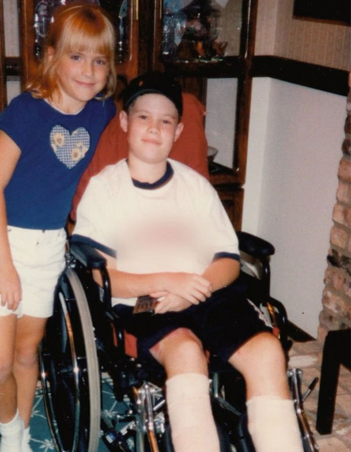 Two children, one in a wheelchair with leg casts, inside a home setting, highlighting 'Pitch Perfect' actor's accident impact. Two children, one in a wheelchair with leg casts, inside a home setting, highlighting 'Pitch Perfect' actor's accident impact.
