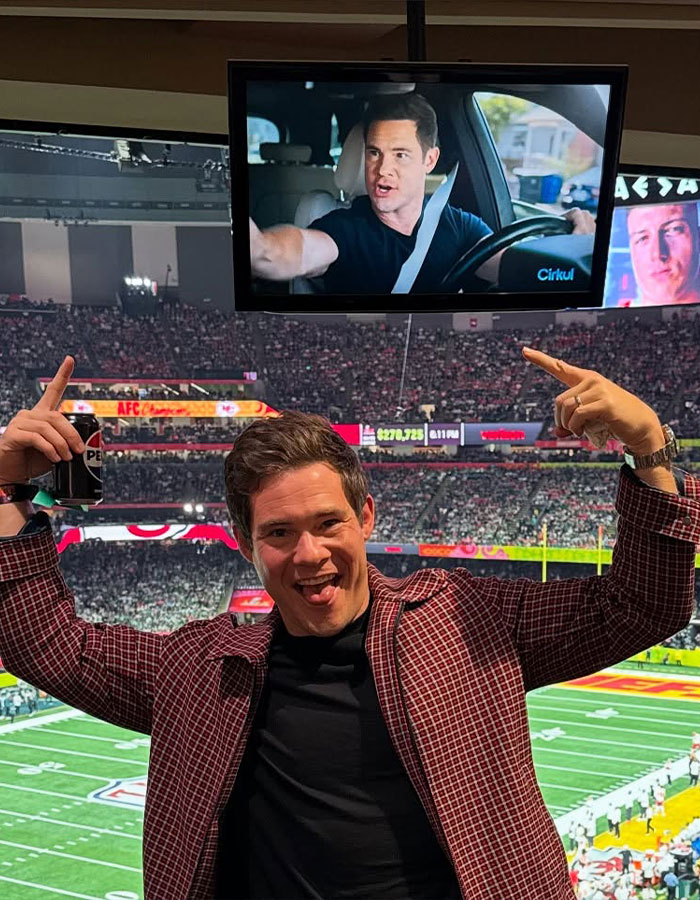 Actor at a football stadium, pointing at a screen showing a scene from a movie. Actor at a football stadium, pointing at a screen showing a scene from a movie.